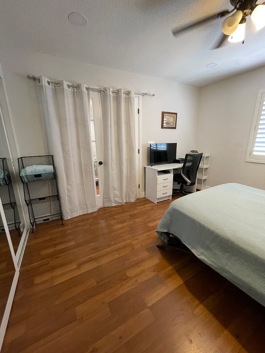 Second bedroom with French doors leading to the living room with black out curtains for privacy