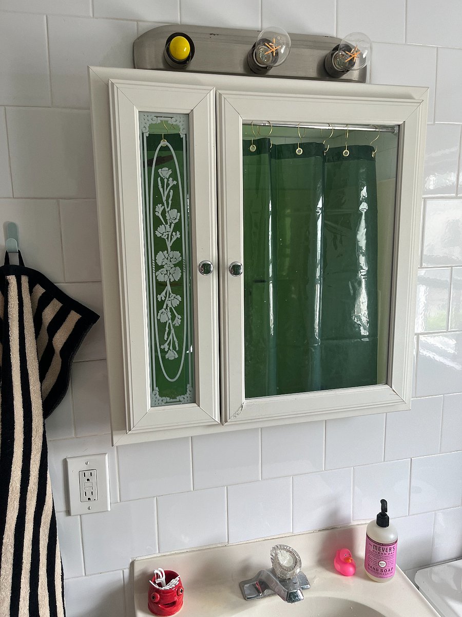 Will need to include a few more bathroom photos :) Cozy bathroom with a bathtub and little cloth curtain. 