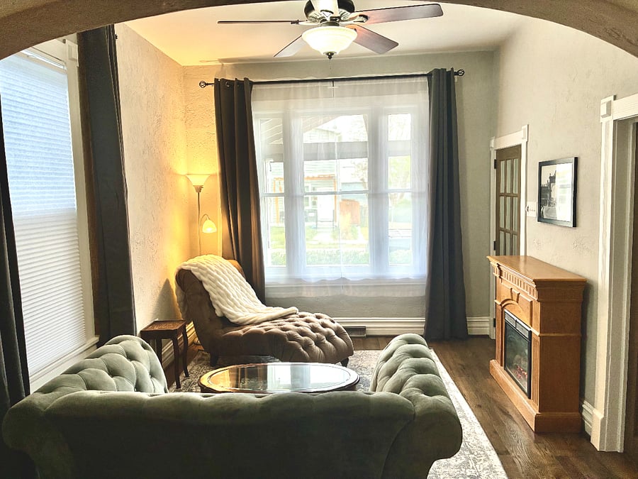 Formal room with electric fireplace and historic Denver decor.