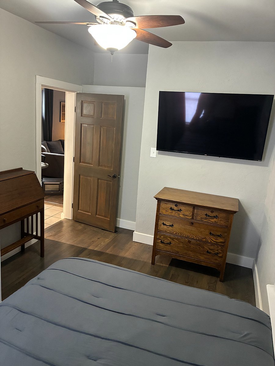 Master Bedroom includes queen bed, dresser, and 55" smart TV.