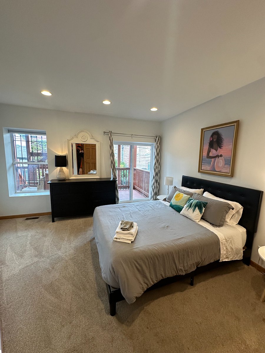 Spacious bedroom with natural light, dresser storage, and a calm setup designed for real rest during an extended Chicago stay.