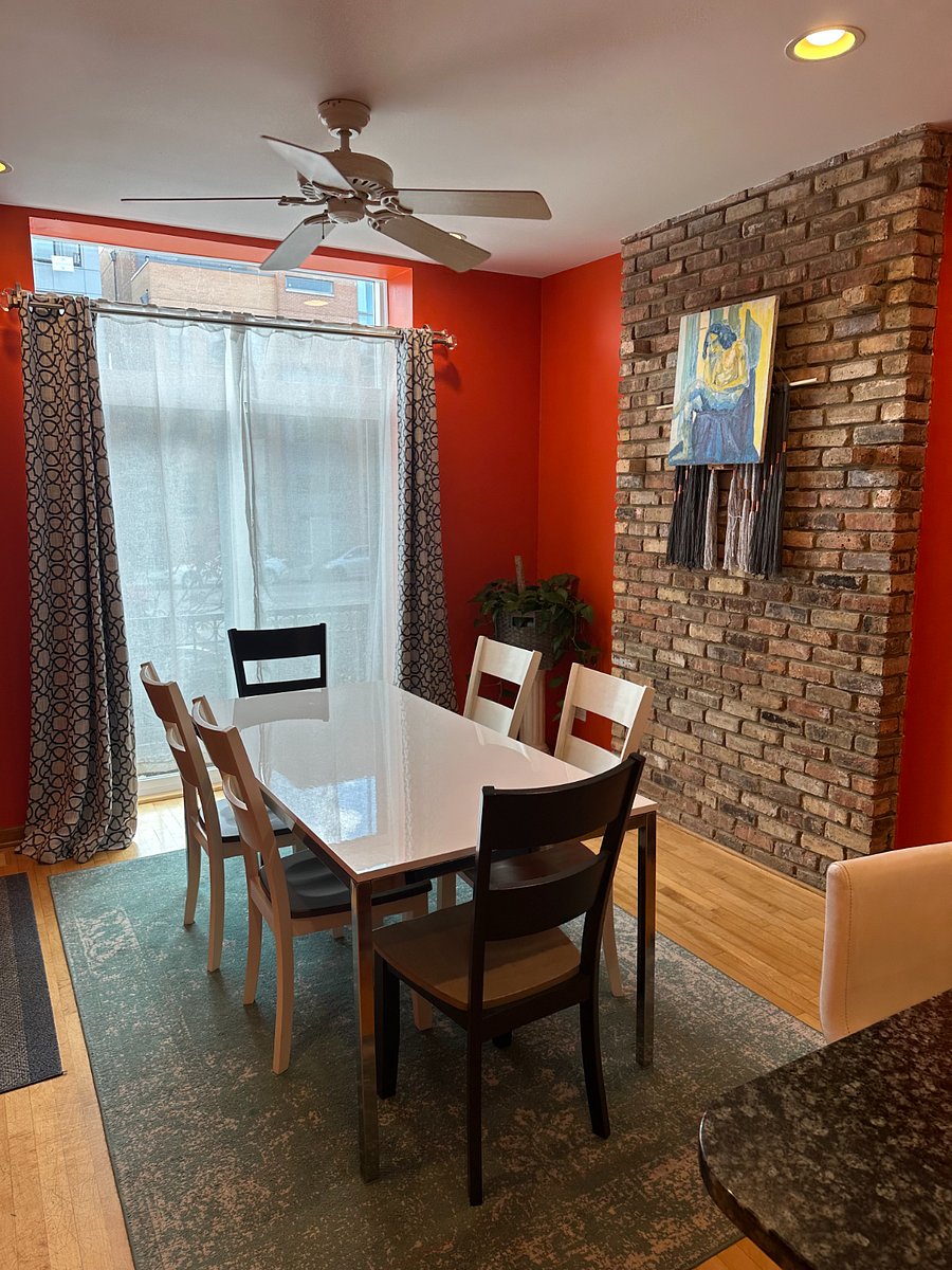 Bright dining nook with a full table that easily doubles as a work zone, meal space, or planning hub for your stay.