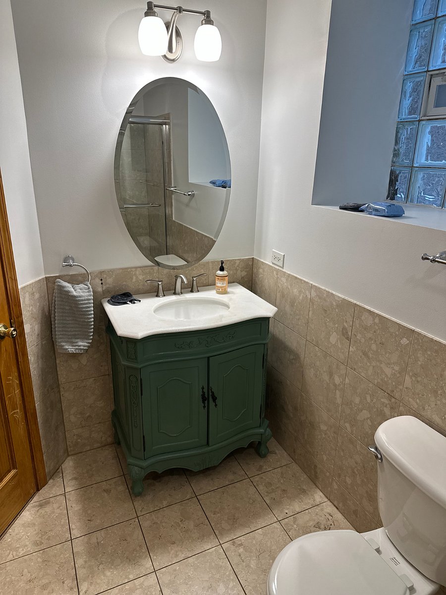 Updated bathroom vanity with storage and clean finishes, giving guests another practical space for daily routines.