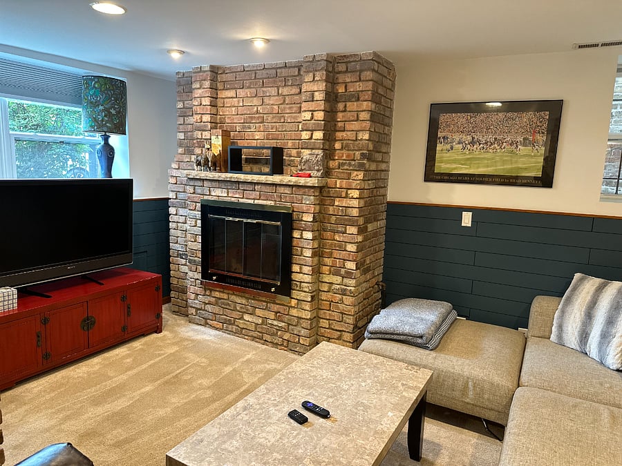 Cozy lounge with fireplace, TV, and sectional seating a comfortable second living space that makes extended stays feel easy.