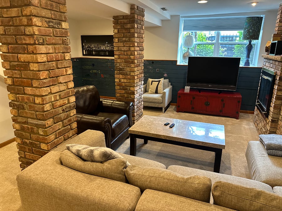 Comfortable TV room with fireplace and sectional sofa perfect for movie nights, quiet mornings, or decompression after a long shift.