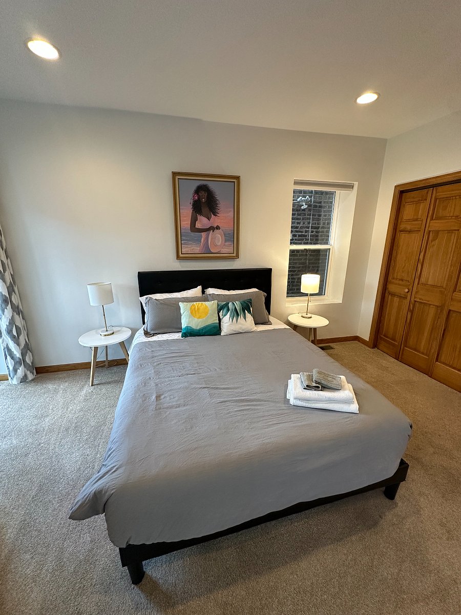 Comfortable queen bedroom with bedside lighting and closet storage simple, restful, and easy to live in.