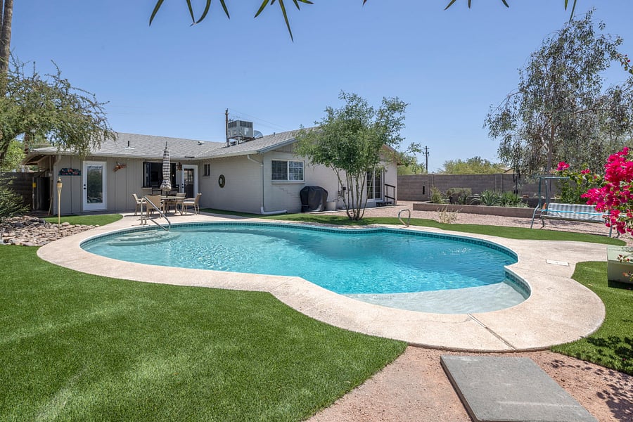 The Ultimate Backyard Retreat: From the pool to the alfresco dining area and the 'California pass-through' kitchen window, this fully fenced sanctuary is designed for the best of Arizona living
