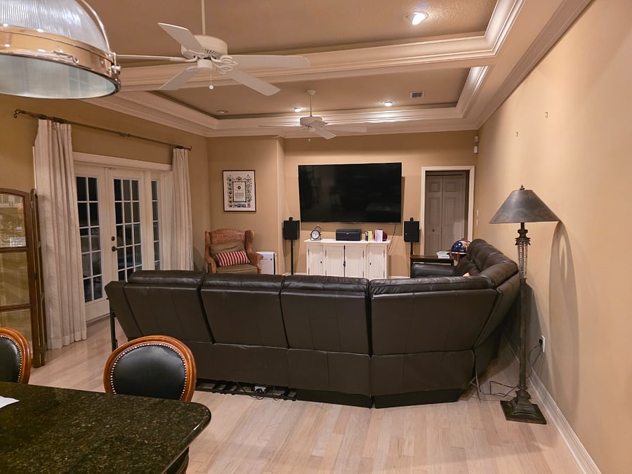 Great room photo taken from Kitchen, with Large TV, Reclining Sofa, door to Pool area