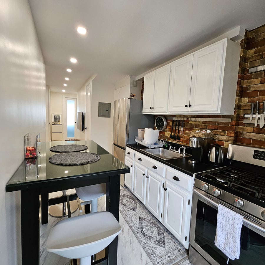 Kitchen is fully equipped with cookware, dishes, and glassware for everyday use.