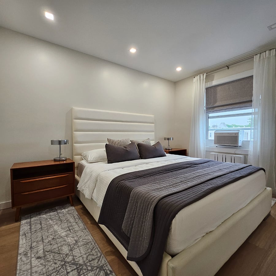 Comfortable master bedroom featuring a king-sized bed, large spacious closet, and blackout curtains.