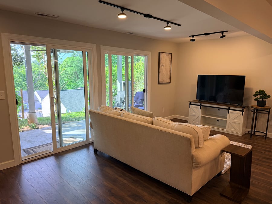 Living room with TV. Doors to covered patio with grill.