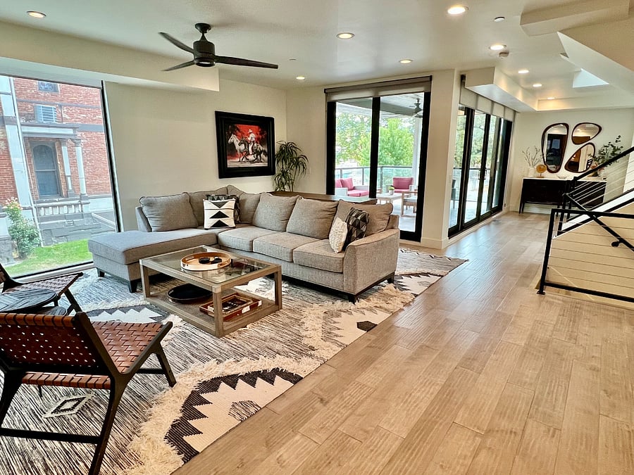 Living room has large sliding glass doors that open onto huge outdoor deck.