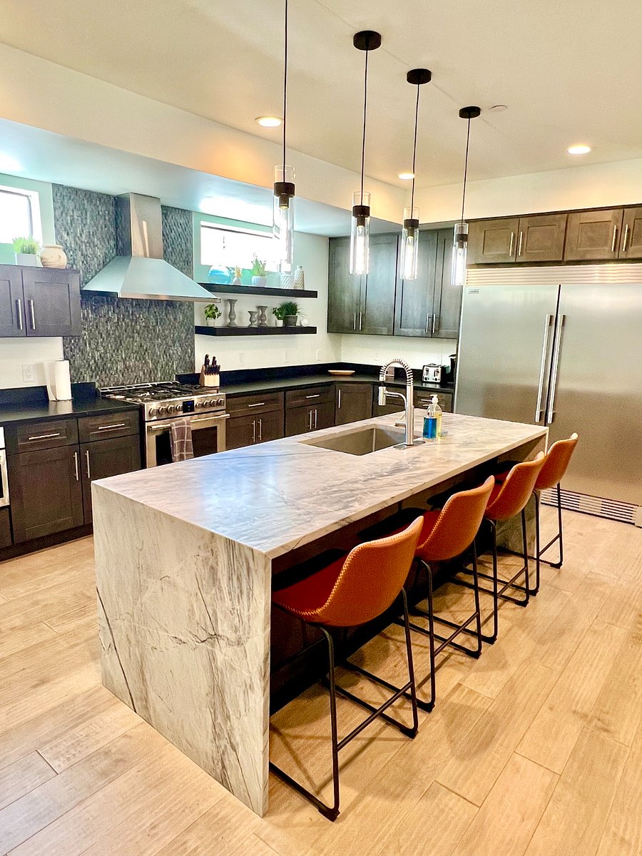 Large modern kitchen with stainless steel appliances, huge refrigerator and freezer, plenty of cabinet storage, large island with huge sink, 4 leather barstools for countertop eating. Completely stocked with all kitchen utensils, pots/pans, coffee maker, microwave, etc..