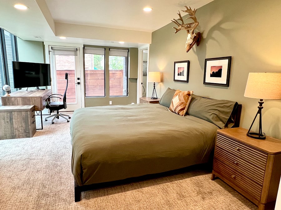 Entry level bedroom. Large room with king size bed, floor to ceiling windows, blackout curtains, desk, 65 Smart TV, closet & en-suite bathroom.