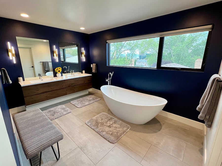 Very large primary bath with dual sinks, sconces, large window for natural light, storage, free standing tub and huge shower.