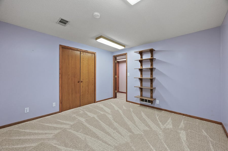 This lower level bedroom has been painted a neutral beige and is available to rent.