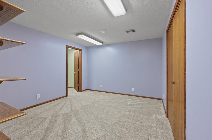 This lower level bedroom has been painted a neutral beige and is available to rent.