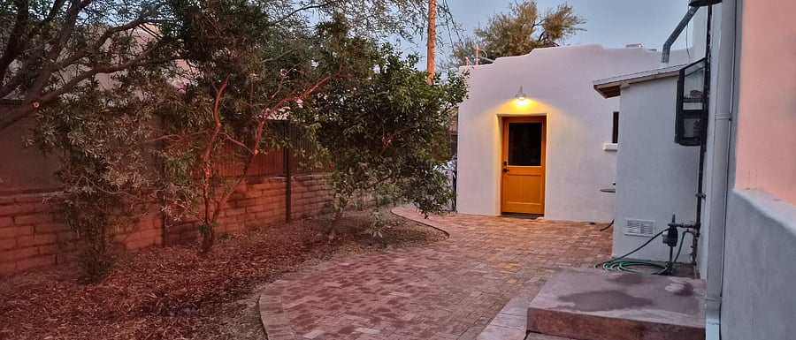 front door with lamp light, patio pavers, 