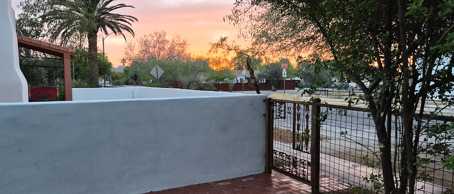 view of sunset over patio wall