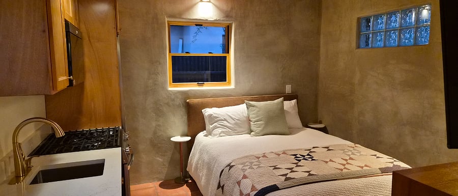 queen bed and artisan plaster walls