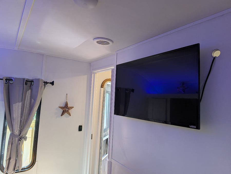 The RV is equipped with a television in both the bedroom and the living room. Experience a soothing atmosphere during the night and morning with our room darkening shades.