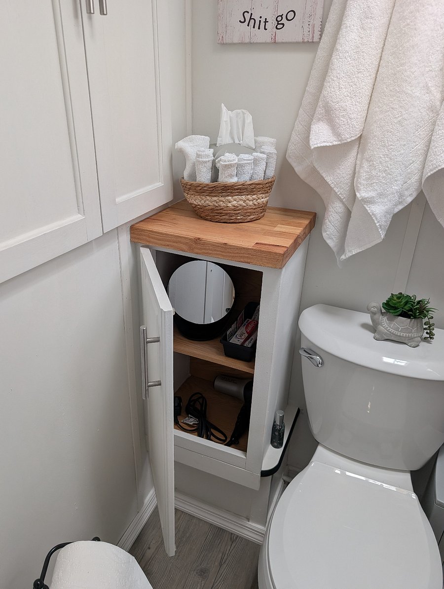 The RV bathroom keeps the comfort going with a complete toilet, an exhaust fan, a sink, and a soothing rain shower.