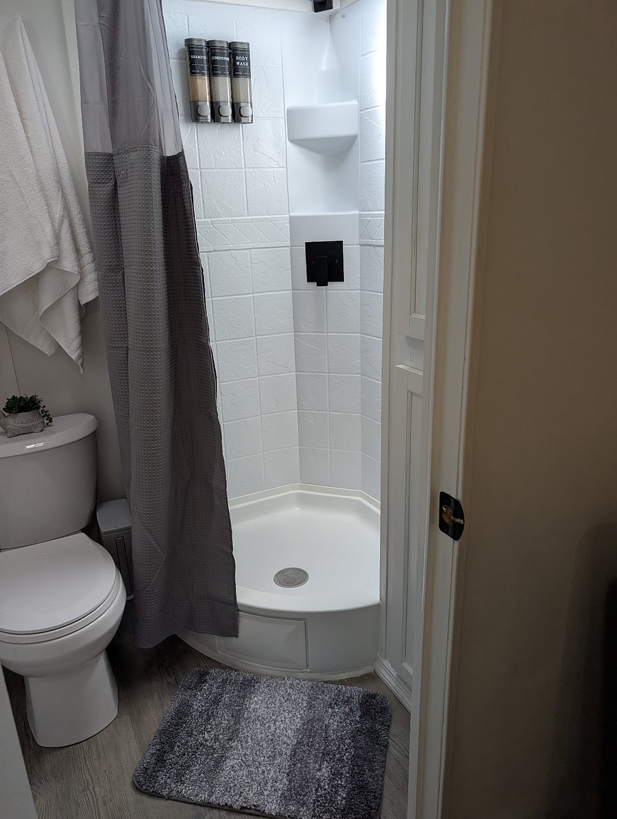 The shower is designed to maximize space for RVs and tiny homes, while still providing a full-sized rain shower experience. Please consider this when making your reservation to ensure that the space meets your expectations.