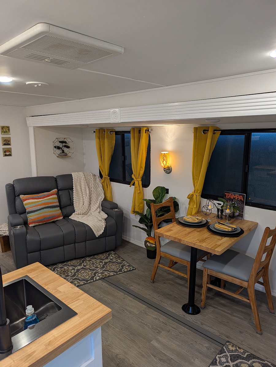 The RV features a cozy living room designed for comfort and relaxation. Enjoy the reclining loveseat after a day of exploring or unwind while watching a show. Large windows and natural light creating a bright and inviting space to relax and recharge.