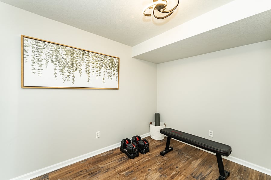 Wellness room, adjustable weights 5-52.5 lbs, weight bench, bands, yoga mats- basement