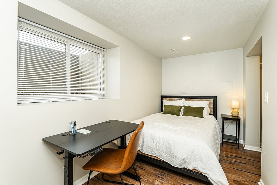 Full bedroom with sitting or standing desk- basement