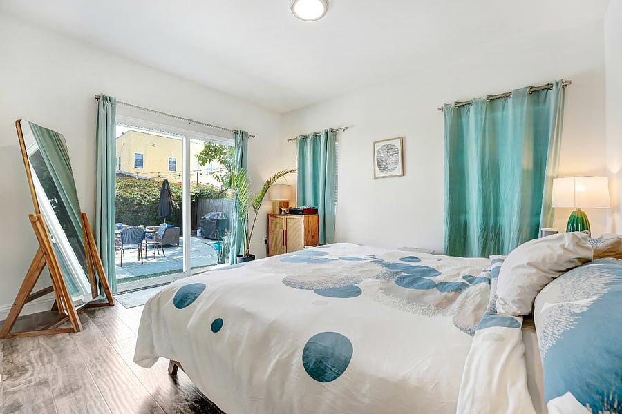King size bed with access and views to the backyard