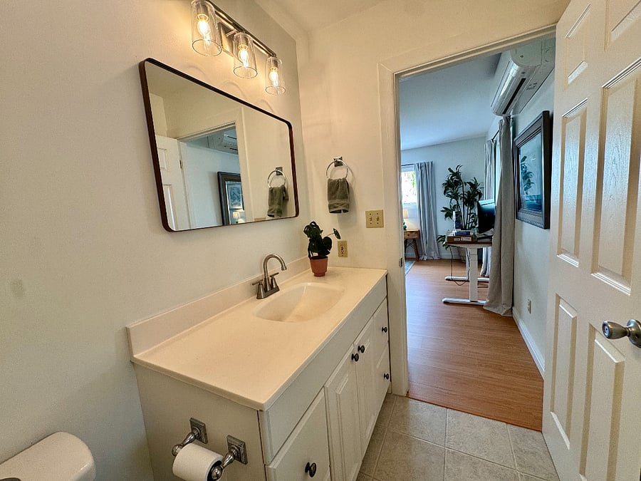 Full private bathroom just steps from the bed. Quality vanity lighting and large mirror.