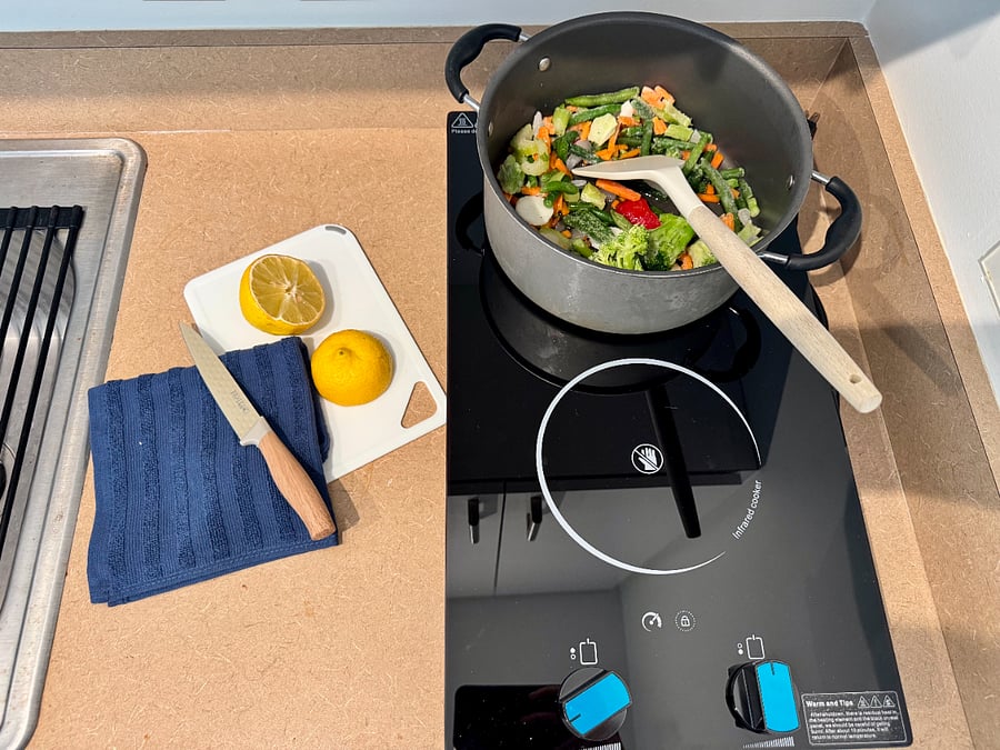 2-burner countertop induction with full induction-safe cookware set provided. Easy cleanup, instant heat.