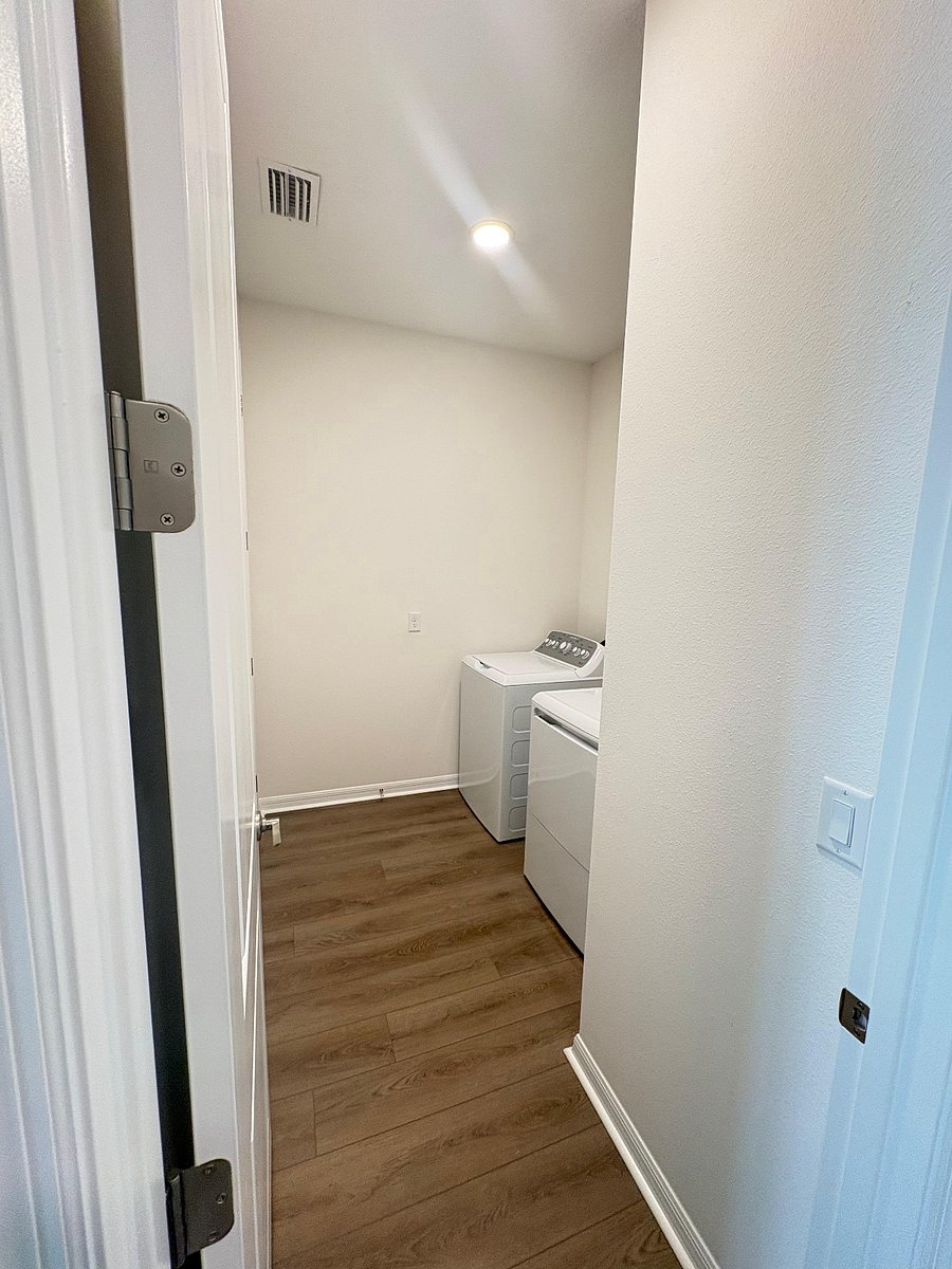Spacious laundry room with large closet for storage