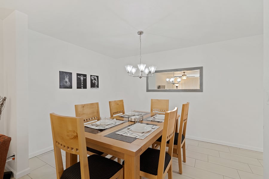 Dining room. Dishes for adults and children.  High chair and booster seat are nearby. 