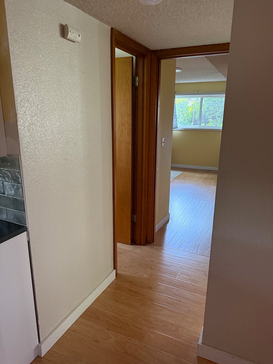 View from kitchen to bedroom. Bathroom on the left.