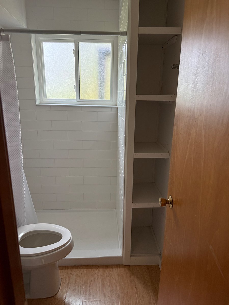 Bathroom storage next to shower.
