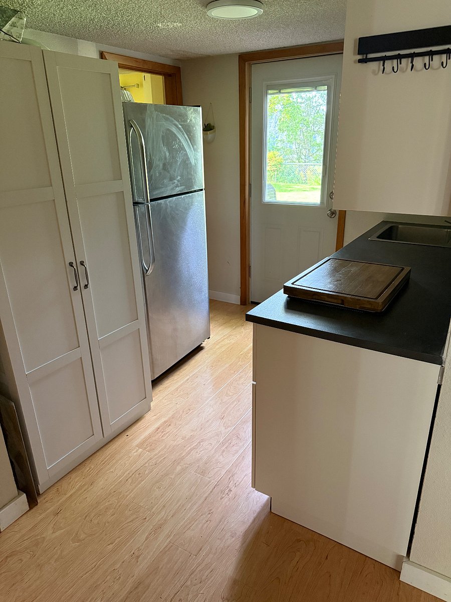 Kitchen pantry next to fridge.
