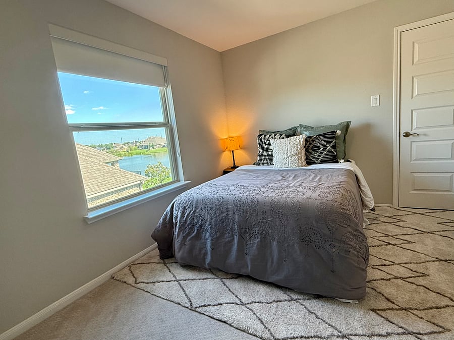 The upstairs bedroom offers a cozy, comfortable space with peaceful water views.