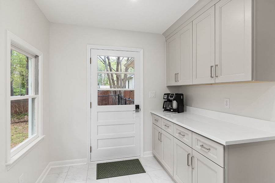 The large laundry and mudroom off the kitchen and back of the house features a brand new washer and dryer and tons of storage.