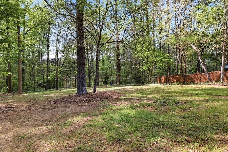 Fenced and wooded backyard - taken from the back of the house. (large storage shed is not for guest use)