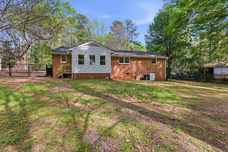 Back of the house with a massive fenced yard