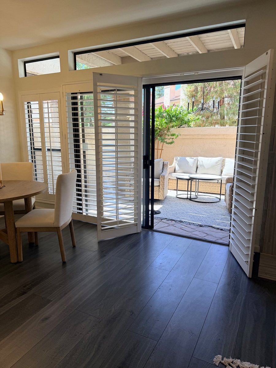Large open slider to outdoor patio with plantation blinds