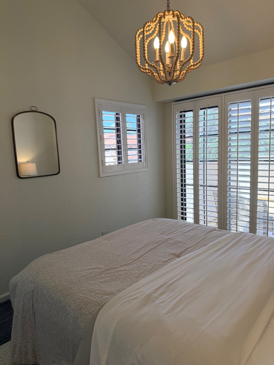 Secondary bedroom with patio and plantation blinds