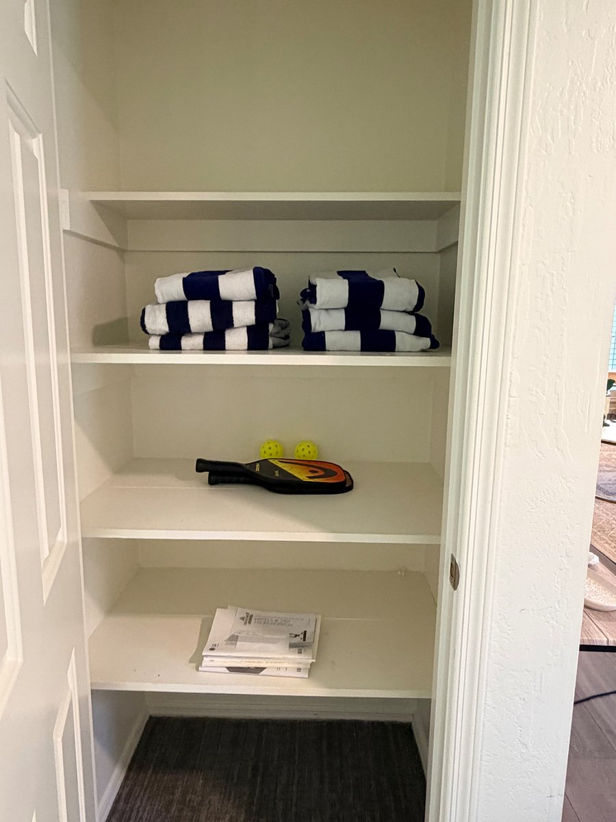 Main level storage linen closet, also a large storage closet under stairs. Pool towels and pickleball equipment