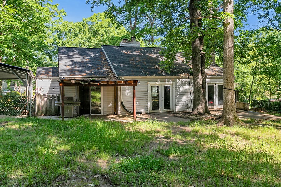 Fully fenced backyard with lean-to patio for grilling area
