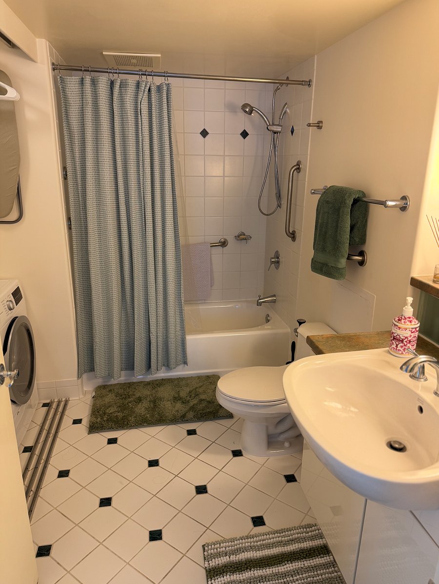 Clean, functional bathroom featuring new shower plumbing.