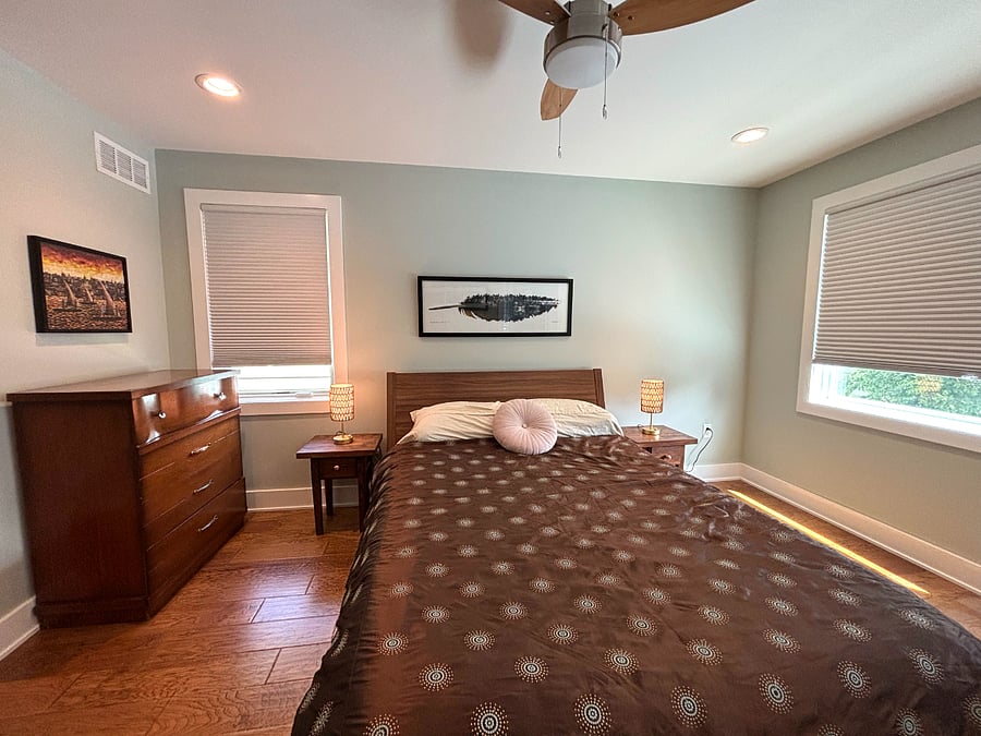 Primary bedroom with queen size bed and attached bathroom