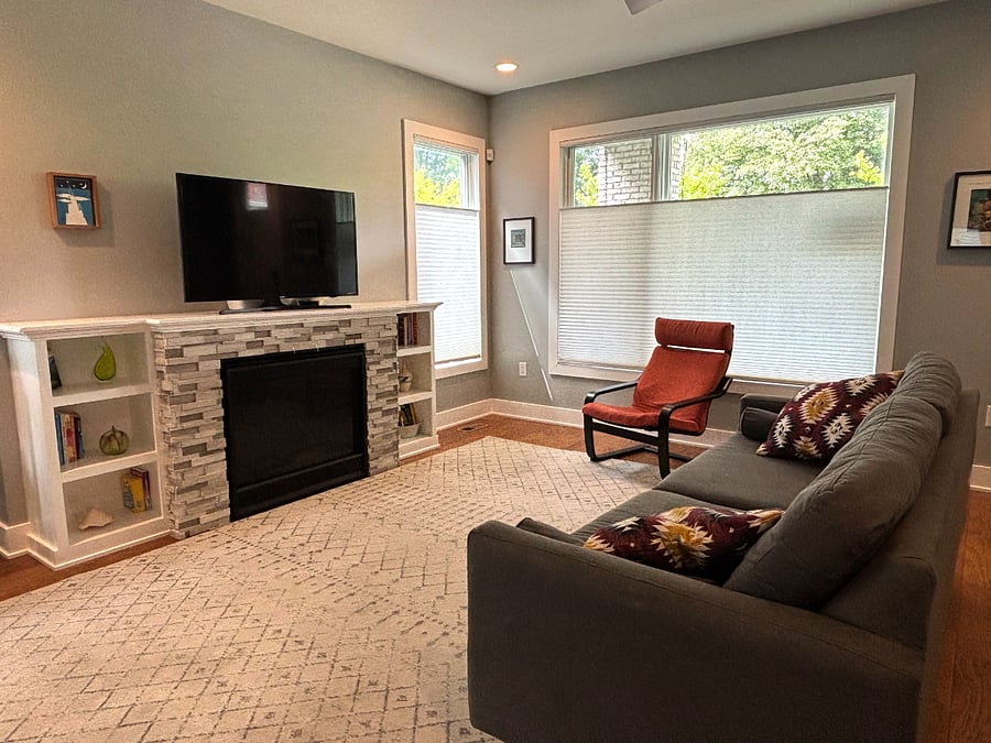 Living room with comfy couch, tv and gas fireplace