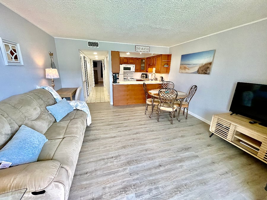 Bright, open living space with comfortable seating and updated flooring
